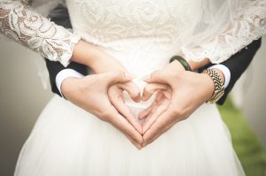 a husband and wife holfing hands for a wedding
